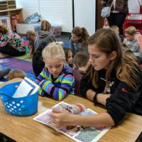 Central Woodlands students help kindergartners read